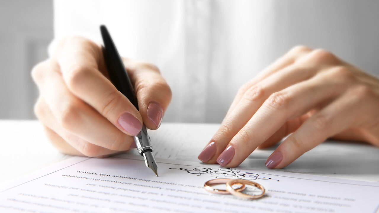 https://watsoncarroll.com/wp-content/uploads/2023/01/Woman-signing-marriage-contract-1-1280x720.jpg